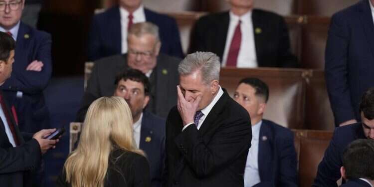 Rep. Kevin McCarthy talks with Rep. Marjorie Taylor Greene at the beginning of an evening session after six failed votes to elect a speaker and convene the 118th Congress in Washington, Jan. 4, 2023 McCarthy repeatedly rejected for House speaker