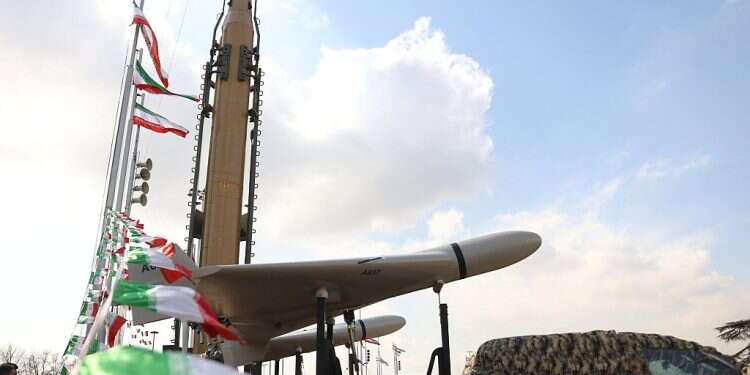A drone is seen next to an Iranian missile during the 44th anniversary of the Islamic Revolution in Tehran, Iran, Feb. 11, 2023 IRGC drones reportedly hit Israeli-linked vessel in Persian Gulf