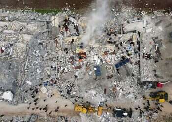 This aerial view shows residents searching for survivors in the rubble of collapsed buildings, following an earthquake on February 6, 2023 Deadly earthquake exacerbates suffering of displaced Syrians