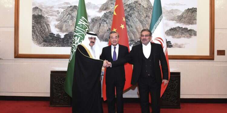 Ali Shamkhani, the secretary of Iran's Supreme National Security Council, at right, shakes hands with Saudi national security adviser Musaad bin Mohammed al-Aiban, at left, as Wang Yi, China's most senior diplomat, looks on in Beijing, Saturday, March 11, 2023 Saudi deal with Iran worries Israel, shakes up Middle East