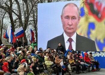 Facing arrest warrant, Putin visits annexed territories