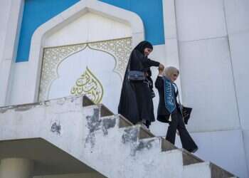 Two students celebrate their graduation at the upscale Qalaat Baghdad restaurant complex built in a former palace of Saddam Hussein along the Tigris River in Baghdad, Iraq, Tuesday, Feb. 28, 2023 20 years after US invasion, young Iraqis see signs of hope