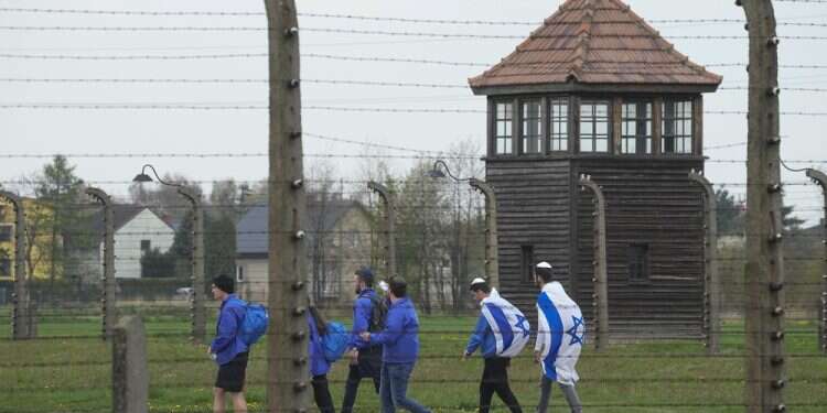 Visitors at the Auschwitz Nazi concentration camp after the March of the Living annual observance, in Oswiecim, Poland, April 28, 2022 (AP/Czarek Sokolowski) Yad Vashem criticizes deal with Poland due to youth trips to 'problematic sites'