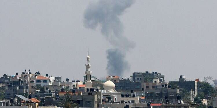 Smoke rises following an Israeli strike, in Khan Younis in the southern Gaza Strip on May 9, 2023 Massive rocket salvo on south, Tel Aviv area as Operation Shield and Arrow continues