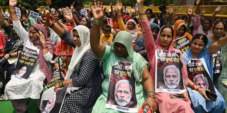 Members of All India Magila Congress hold placards with portrait of Indian Prime Minister Narendra Modi with a message reading 'Modi break your silence on Manipur' during a protest over sexual violence against women and for peace in the ongoing ethnic violence in India's north-eastern state of Manipur, in New Delhi on July 20, 2023 India's Modi calls alleged Manipur sexual assault 'shameful', promises tough action