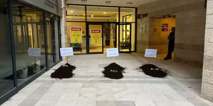 Left-wing groups display fake graves in protest of settler violence