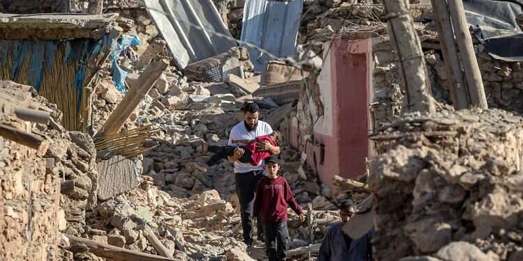 People walk past destroyed houses after an earthquake in the mountain village of Tafeghaghte, southwest of the city of Marrakesh, Sept. 9, 2023
Morocco's deadliest earthquake in decades has killed more than 1,300 people, authorities said on September 9, as troops and emergency services scrambled to reach remote mountain villages where casualties are still feared trapped. (Photo by FADEL SENNA / AFP) Israel announces relief mission to Morocco after earthquake kills thousands