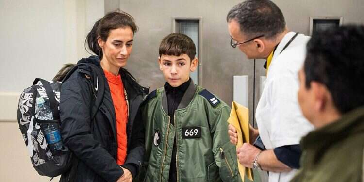 Former French-Israeli hostage, 12-year-old Eitan Yahalomi (C), reunited with his mother following his release by Hamas from the Gaza Strip, at the Sourasky Medical Center in Tel Aviv early on November 28, 2023 The innocence we all need: What the captive children teach us about the path to victory