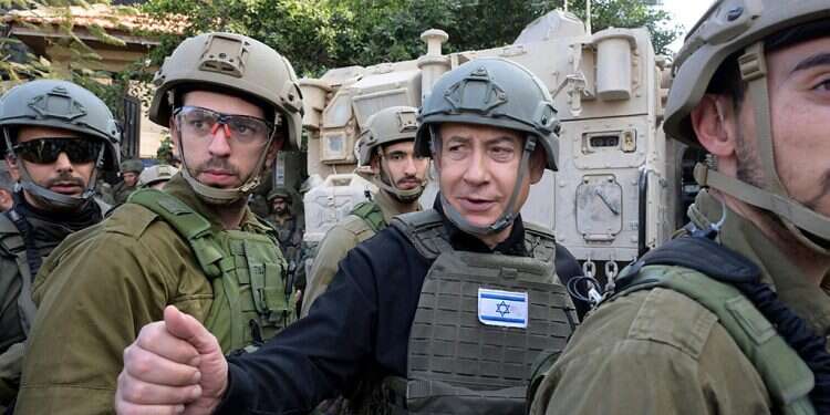 Israeli Prime Minister Benjamin Netanyahu, center, wears a protective vest and helmet as he receives a security briefing with commanders and soldiers in the northern Gaza Strip, on Monday, Dec. 25, 2023 Egypt floats ambitious plan to end war as Netanyahu vows to expand combat