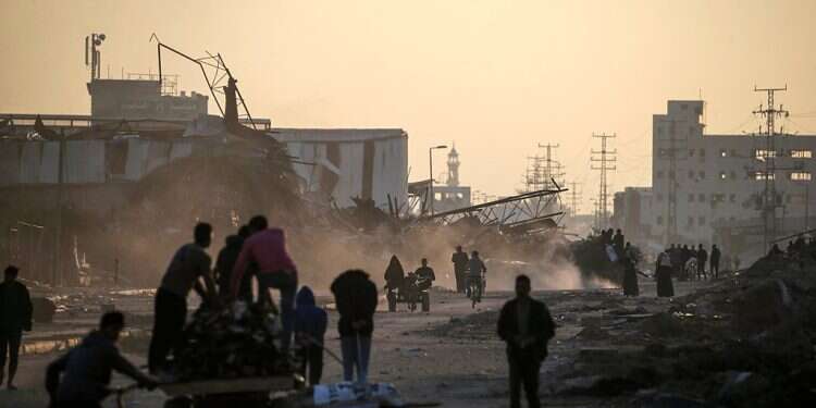 People walk among destroyed houses and buildings along Salah Al Din road during Israeli anti-terrorism operation in southern Gaza Strip, Jan. 19, 2024 LIVEBLOG: PM says 'new Nazis' of Hamas must be destroyed lest next massacre occurs