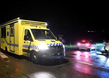 An ambulance drives past a road blocked by Swiss Gendarmes leading to a train station in Essert-Sous-Champvent, western Switzerland, Feb. 8, 2024 Jewish man stabbed by teenager in Zurich in suspected antisemitic attack