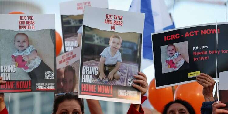 Protesters hold banners as they call for the immediate release of hostages, especially Shiri Bibas, 32, her husband Yarden Bibas, 34 and their children Kfir Bibas, who turned 1 in captivity, and Ariel, 4, Tel Aviv, Israel, Nov. 28, 2023 Israel-Hamas ceasefire talks resume in Qatar