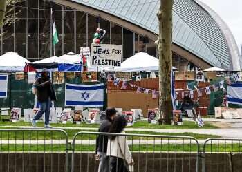 People walk past the ongoing pro-Palestinian encampment on the campus of the Massachusetts Institute of Technology (MIT), in Cambridge, Massachusetts, May 3, 2024 Outrage after MIT students appear to call for 'Death to Zionists'
