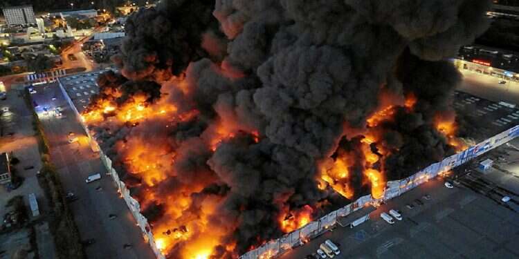 Drone view of the Marywilska 44 shopping center burning during a massive fire in Warsaw, Poland, May 12, 2024 Massive fire engulfs Warsaw shopping complex