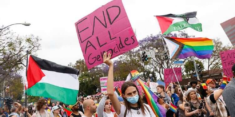 Parade paticipants hold up pro-Palestine signs and flags as they walk in the 2024 WeHo Pride Parade in West Hollywood, California, USA, on June 2, 2024 Pro-Palestinian demonstrators block LGBTQ+ pride parade in Philadelphia