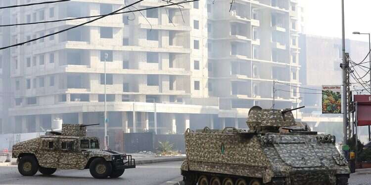 The Lebanese national army soldiers take position in a residential neighborhood after fierce gun battles erupted during a protest near the Justice Palace in Beirut along a former civil war front line between Muslim Shiite and Christian areas on October 14, 2021 in Beirut, Lebanon. There are reports of 5 dead and 20 injured so far in Beirut, after protesters demanded the dismissal of judge Tarek Bitar, responsible for investigating the explosion at the port of Beirut in 2020 US Embassy in Beirut attacked; no casualties reported