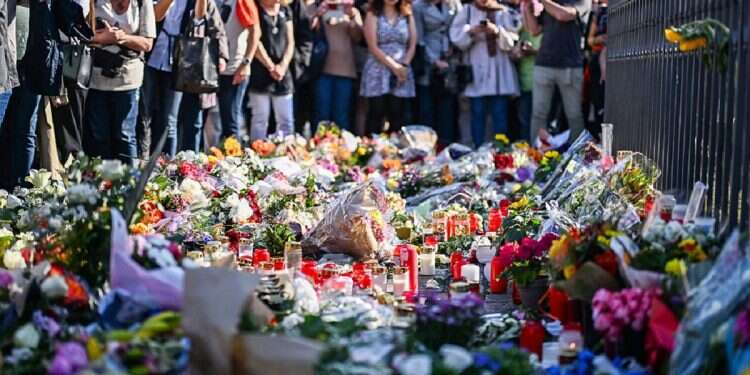 People attend a rally under the motto 'Mannheim sticks together' in Mannheim Germany, Monday, on June 3, 2024 after a German police officer has died on Sunday of injuries suffered during a knife attack German politician stabbed in Mannheim, 2nd time in less than a week