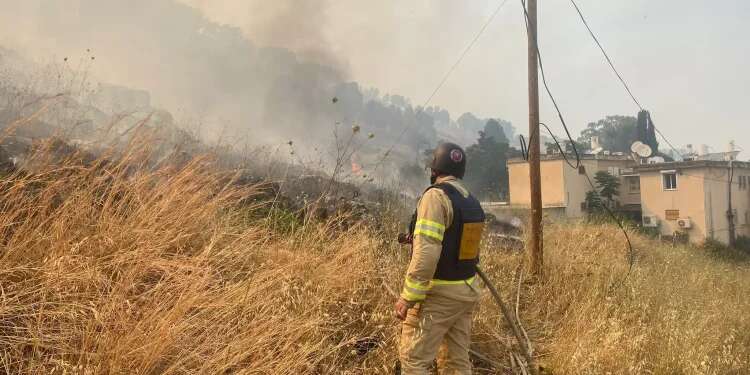 Israeli fire fighters near the site of the rocket attack in northern Israel, June 3, 2024 Firefighters respond to blaze following Hezbollah rockets