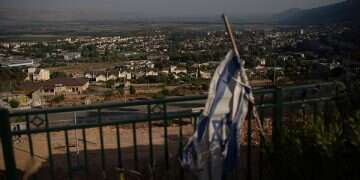 An Israel flag hangs on an area backdropped by buildings in Kiryat Shmona. Photo/Leo Correa, AP The forgotten war zone