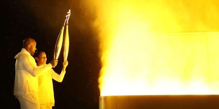 Marie-José Pérec and Teddy Riner light the Olympic Cauldron at the Paris 2024 opening ceremony