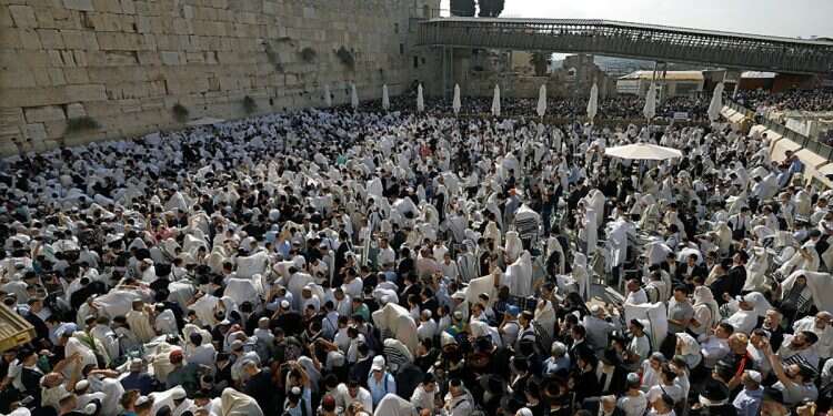 Ultra-Orthodox Jews cover their heads with shawls during special prayers at the Western Wall as they attend a mass priestly blessing in the Old City of Jerusalem, October 16, 2019 Learning from destruction: Our critical need for unity