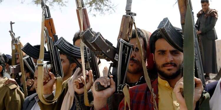 Armed Houthi supporters hold up weapons during a gathering to mobilize more fighters into the battlefronts amid an escalating war between the Houthis and Saudi-backed Yemeni troops, in Sana'a, Yemen, November 24, 2021 Houthis take over UN headquarters in Sanaa
