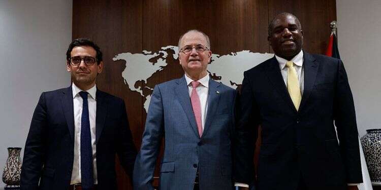 Palestinian Prime Minister Mohammed Mustafa poses for a picture with French Foreign Minister Stephane Sejourne (L) and British Foreign Minister David Lammy (R) in the city of Ramallah in the West Bank on August 16, 2024 UK foreign secretary removes hostage pin for PA prime minister