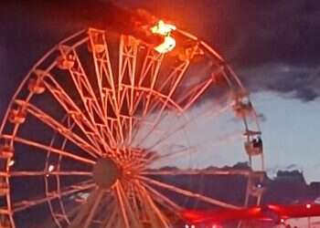 Two gondolas of a Ferris wheel caught fire