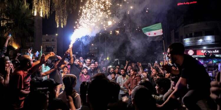 Syrians gather in the rebel-held northwestern city of Idlib in the early hours of September 28, 2024, following news claiming the death of Lebanon's Hezbollah chief Hassan Nasrallah in an Israeli airstrike on Beirut's southern suburbs on September 27, 2024 (AFP/Haj Kadour) Nasrallah's seismic death cracked the Iranian axis