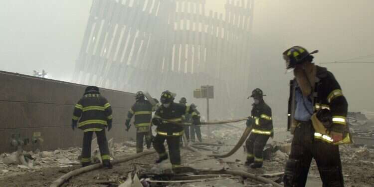 Firefighters work beneath the destroyed mullions, the vertical struts which once faced the outer walls of the World Trade Center towers (Spencer Platt/Getty Images/AFP) How one moment on 9/11 led to a marriage proposal