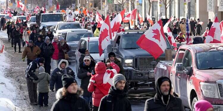 Trucks and supporters travel down Bloor Street during a demonstration in support of a trucker convoy in Ottawa protesting COVID-19 restrictions, in Toronto, Saturday, Feb. 5, 2022 Jewish safety patrols form at University of Toronto
