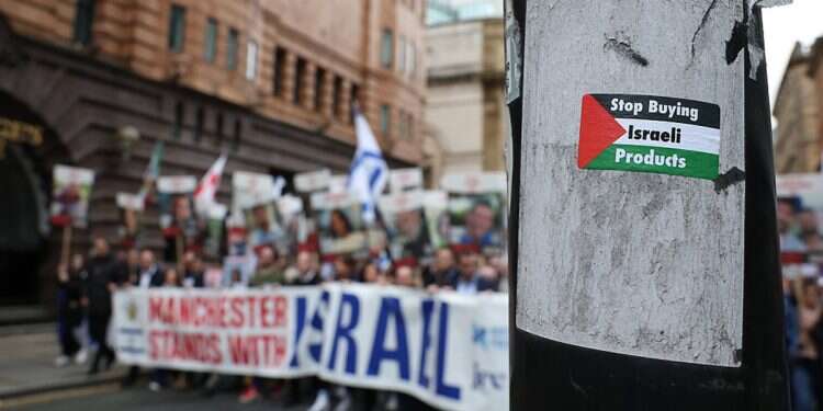 Protesters march past a sticker stuck to a lamp post during a 'Manchester Stands with Israel' rally, organized by the NorthWest Friends of Israel, in Manchester, Britain, 06 October 2024 Stolen bust of Israeli president beheaded in Manchester