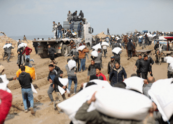 Palestinians carry bags of flour they grabbed from an aid truck near an Israeli checkpoint, Gaza City, Feb. 19, 2024 Footage of Hamas brutally interrogating Gazans uncovered