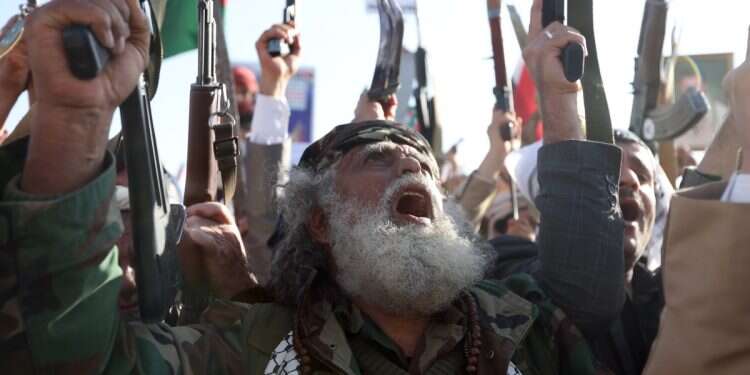 Houthi supporters shout slogans as they hold their weapons up during a rally marking the International Day of Solidarity with the Palestinian People, in Sana'a, Yemen, 29 November, 2024 Inside the Houthi bid to become Iran's favorite proxy