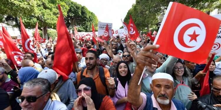 Supporters of the Tunisian Islamist Ennahda party wave national flags and raise placards during a demonstration against President Kais Saied in the capital Tunis, on October 15, 2022 Why is the US selling weapons to Tunisia?