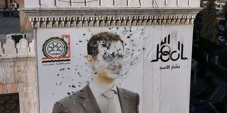 A bullet-riddled portrait of Syrian President Bashar Assad adorning Hama's municipality building after it was defaced following the capture of the city by anti government fighters, on December 6, 2024 What's next for Syria?