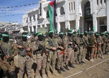 The triumphant face of IDF female soldiers in front of the masked barbarians of Hamas