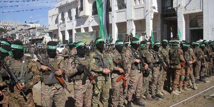 The triumphant face of IDF female soldiers in front of the masked barbarians of Hamas