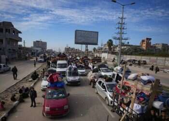 Palestinians with their belongings gather near a roadblock on Salah al-Din Street on Jan. 26, 2024 Hamas tries to use civilians to breach Gaza road amid deal uncertainties