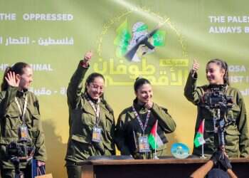 The triumphant face of IDF female soldiers in front of the masked barbarians of Hamas