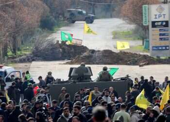 Locals hold Hezbollah flags as they gather in Burj al-Muluk, near the southern Lebanese village of Kfar Kila on January 26, 2025 Israel, Lebanese clash amid Hezbollah-led border crisis