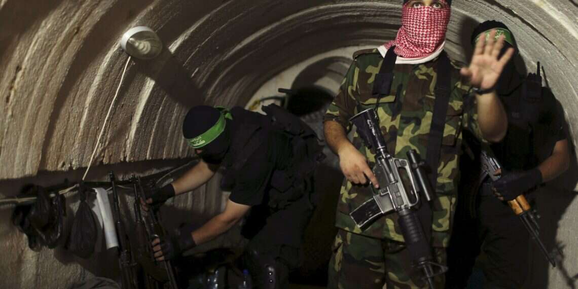 A Palestinian terrorist from the Izz el-Deen al-Qassam Brigades, the armed wing of the Hamas movement, gestures inside an underground tunnel in Gaza on August 18, 2014 Web of war: Inside Gaza's tunnels