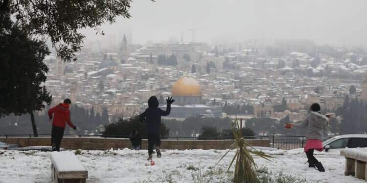 Children play as the old city is covered in snow, in Jerusalem, Israel, on February 18, 2021. Photo credit: Abir Sultan/EPA It's official: This is the storm approaching Israel