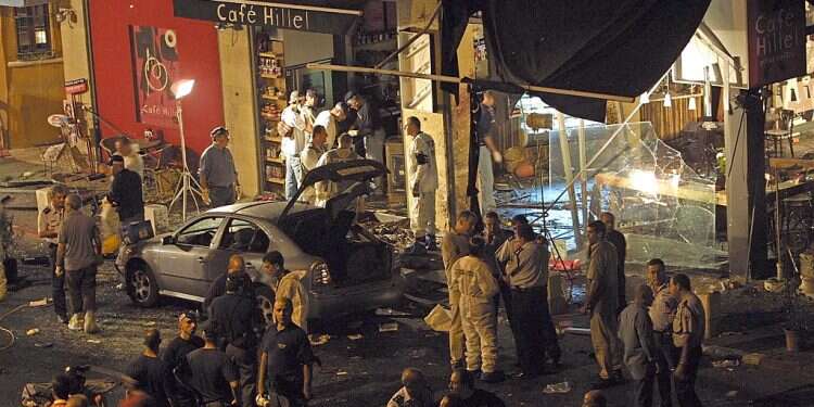Israeli police and rescue workers work at Cafe Hillel where a suicide bomber blew himself up, killing at least seven people and injuring 57 others on September 9, 2002 in Jerusalem Divine intervention? Terrorist dies week after release