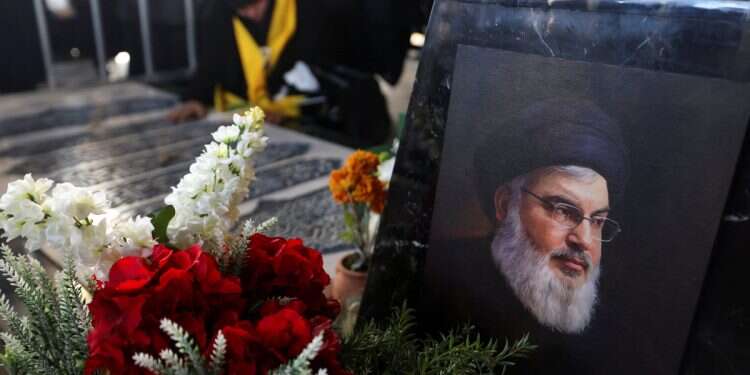 A picture of former Hezbollah leader Hassan Nasrallah, who was killed during Israeli airstrikes in Beirut last year, is placed at his burial site on the outskirts of Beirut, Lebanon February 24, 2025 NY students attend Nasrallah vigil but don't know who he was