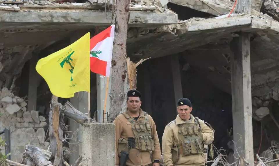Lebanese army soldiers near Hezbollah and Lebanese flags (Archive) 'Balance of power in Lebanon has shifted': Hezbollah fears normalization