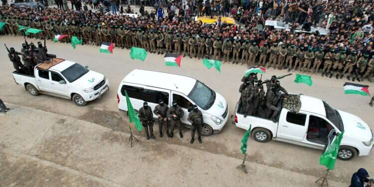 A drone view shows Palestinian Hamas militants parading on the day Or Levy, Eli Sharabi and Ohad Ben Ami, hostages held in Gaza since the deadly October 7, 2023 attack, are released as part of a ceasefire and a hostages-prisoners swap deal between Hamas and Israel in Deir Al-Balah in the central Gaza Strip, February 8, 2025 (Photo: Reuters/Stringer) The Iran files: Proof of Iran's direct role in planning Oct. 7