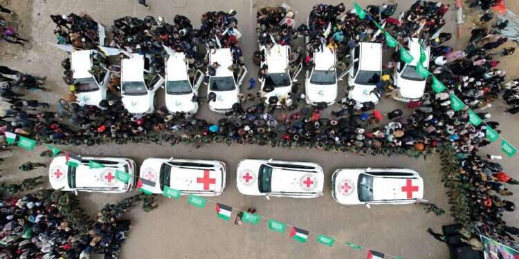 Gazans and Hamas terrorists gathering around International Committee of the Red Cross (ICRC) vehicles on the day Avera Mengistu, who entered Gaza around a decade ago and has been held there since, and Tal Shoham, a hostage held in Gaza since the deadly Oct. 7, 2023 attack, are released as part of a ceasefire and a hostages-prisoners swap deal between Hamas and Israel, in Rafah, in the southern Gaza Strip, February 22, 2025 Egyptian FM confirms hostage deal, ceasefire proposal submitted