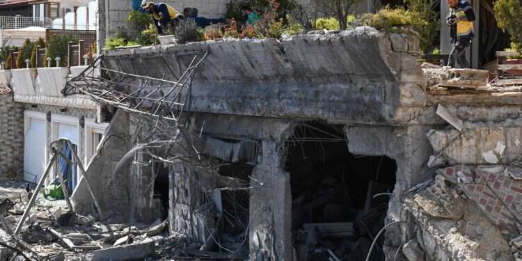 Syrian White Helmets rescuers check the site of an Israeli air strike on a building in Damascus in an area where Palestinian leaders are known to reside, on March 13, 2025 'You will pay a heavy price:' Defense minister threatens al-Julani