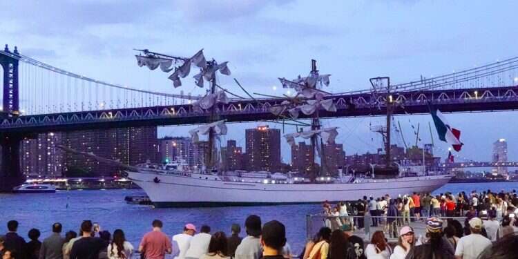 People look at the Cuauhtemoc, a Mexican Navy training boat, as it sits in the East River after the ship hit the Brooklyn Bridge, in New York, New York, 17 May 2025 Mexican ship crashes into Brooklyn Bridge, leaves 2 dead
